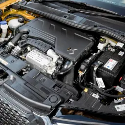 Silnik 1.6 PureTech pod maską samochodu, z widocznym akumulatorem i elementami układu dolotowego.