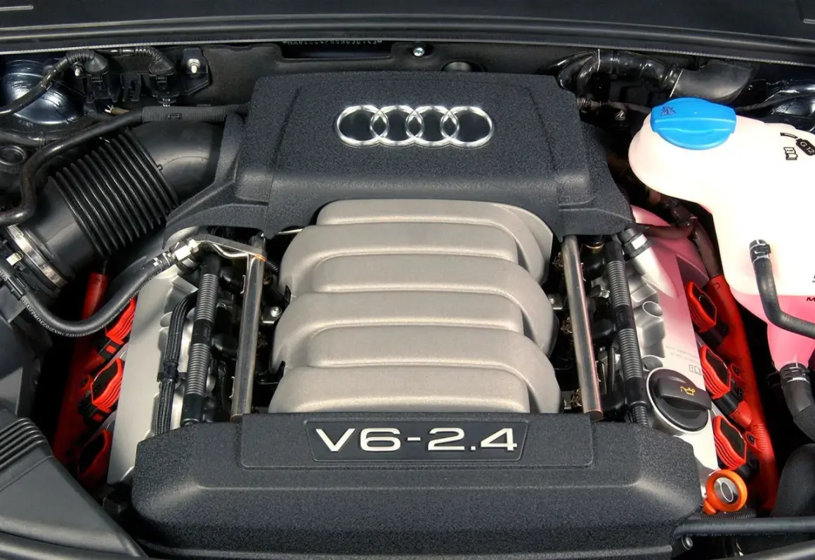 Silnik V6 2.4 z Audi C6, z widocznymi cewkami zapłonowymi i logo Audi.